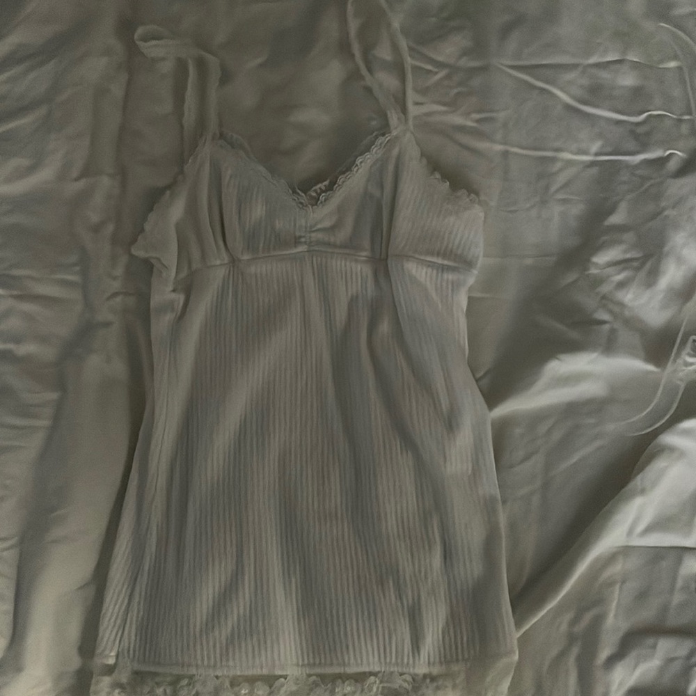 Fits like a small. Lacey tank top.